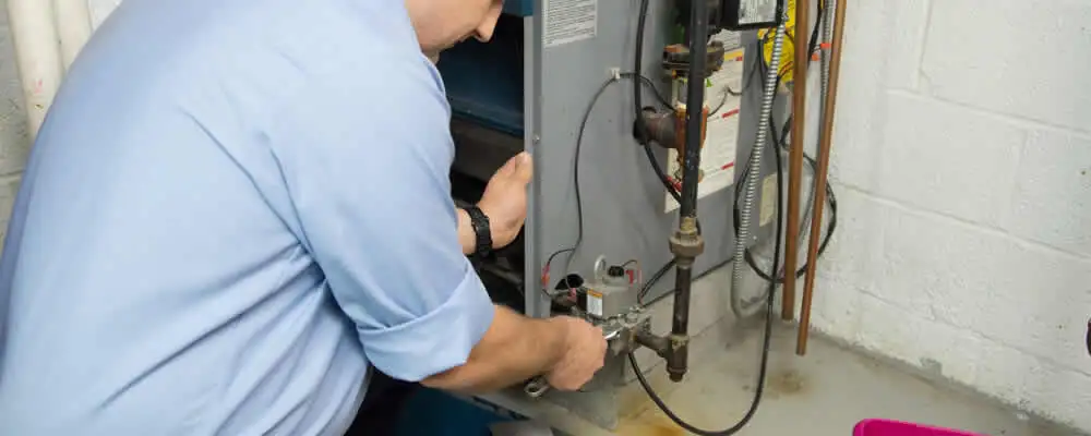 Furnace repair technician inspecting and servicing a home heating system in Austin, TX
