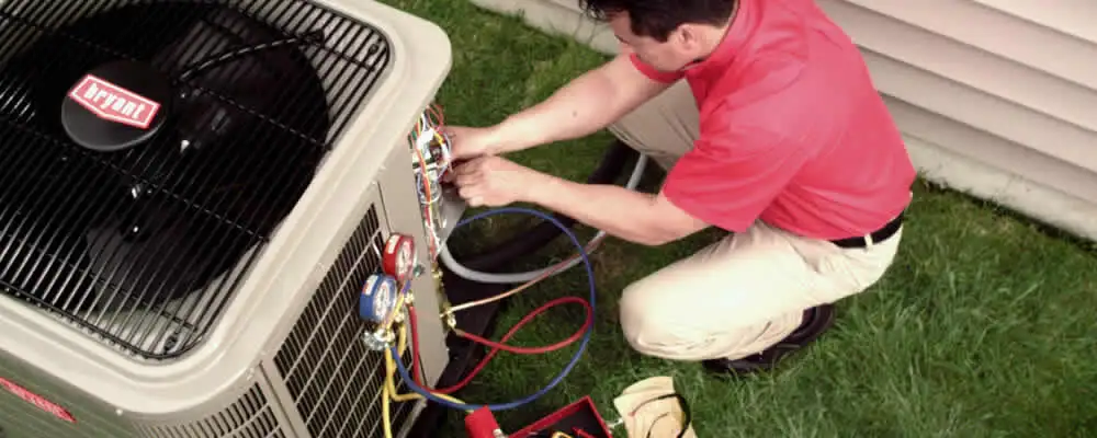 HVAC technician servicing an outdoor air conditioner unit in Austin, TX