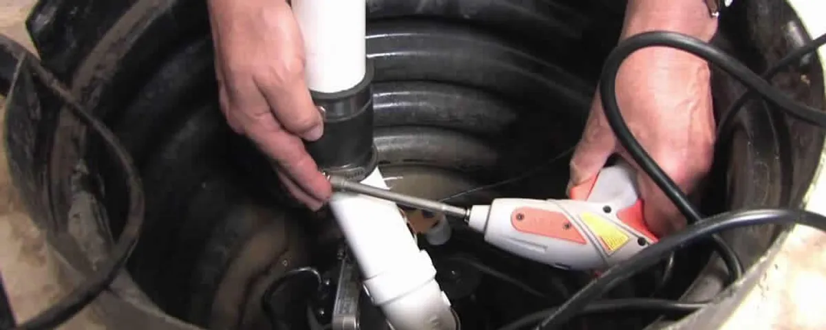 Sump pump installation technician connecting PVC discharge piping in Austin, TX